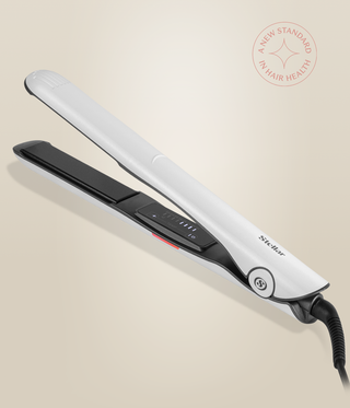 Pearl White Omnia Styler Classic lying open, with black plates and control panel visible.