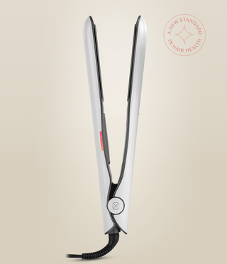 Side view of the Pearl White Omnia Styler Plus standing open, showing the hinge and cord.